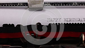 flowing text HAPPY BIRTHDAY written with old typewriter with black ink