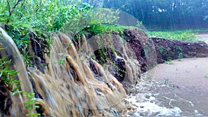 Flowing water causing soil erosion during heavy rain and flood