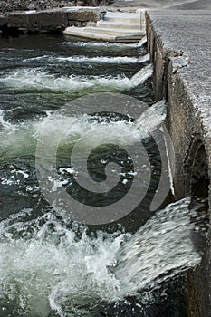 Flowing water drainage with strong stream into the ocean