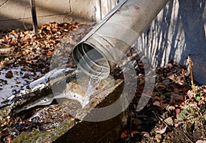 Flowing water from the roof through tin gutter