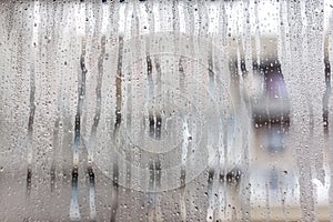 Flows on the misted window-glass. Close-up. Background