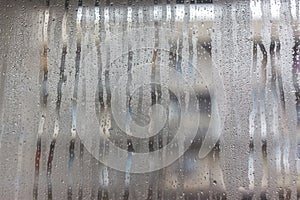 Flows on the misted window-glass. Close-up. Background