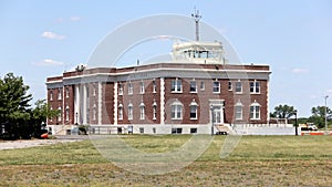 Floyd Bennett Field, terminal and control tower, side view across grass covered airfield, New York, NY, USA