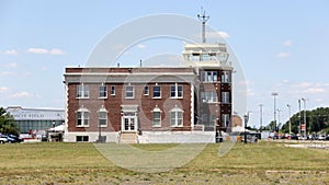 Floyd Bennett Field, terminal and control tower, side view across grass covered airfield, New York, NY, USA