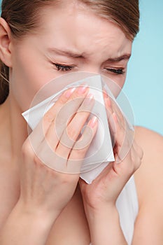 Flu allergy. Sick girl sneezing in tissue. Health