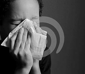 The flu child blowing nose after catching a cold with background stock photo