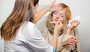 Flu and cold treatment. Woman consult with doctor. Girl in scarf examined by doctor. Cold and flu remedies. Doctor