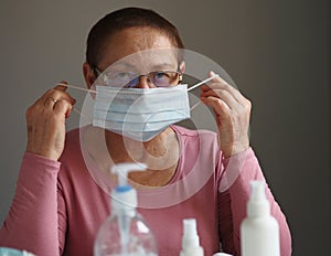 During a flu epidemic, an elderly woman wears a protective medical mask to protect herself from coronavirus and dust allergies