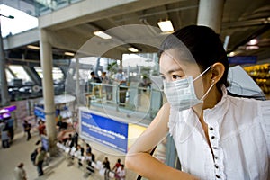 With flu mask at the airport