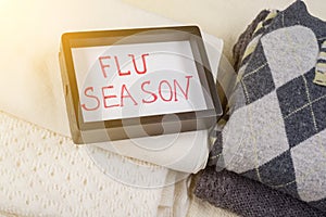 Flu season - text frame. Background - warm woolen clothes