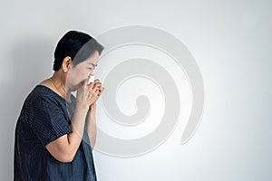 Flu senior asian woman and using tissue paper,Elderly female sneezing,Copy space for text on white background