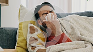 Flu, sick and cold man sneezing, blowing and cleaning runny nose with tissues while ill with covid, sinus and allergies