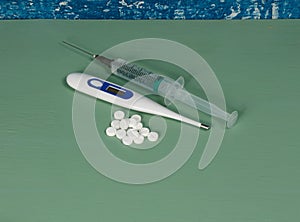 Flu. Syringe tablets and thermometer.