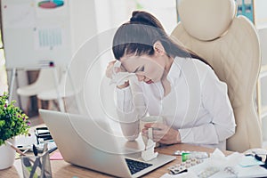 Flu at work. Tired sick business lady lawyer with strong migraine grimace. She is wearing the formalwear, sitting