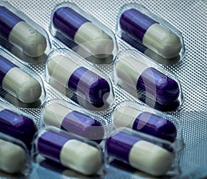 Fluconazole : Antifungal medicine. Full frame picture of purple, white capsule pills. Healthcare concept. Medicine pills photo