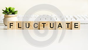 fluctuate word made with wooden blocks, concept