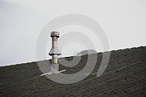 Flue chimney fixed to building exterior wall stainless steel from exhaust boiler plant room