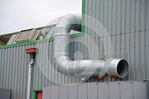 Flue chimney fixed to building exterior wall stainless steel from exhaust boiler plant room