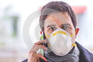 Flue and corona safety concept. Business man wearing face mask to protect himself and using smartphone. Outdoors