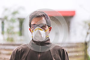 Flue and corona safety concept. Man wearing face mask to protect himself, outdoors