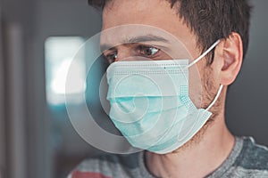 Flue and corona safety concept. Portrait of man wearing face mask to protect himself