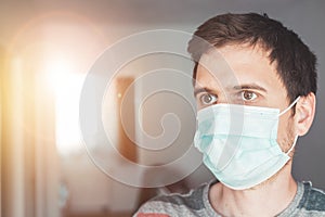 Flue and corona safety concept. Portrait of man wearing face mask to protect himself