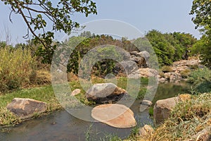 fluent river with rocks and vegetation in Africa. Lubango. Angola.