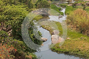 fluent river with rocks, vegetation, fisherman and boat in africa. Lubango. Angola.