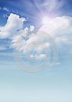 Fluffy clouds with sun on the sky, soft focus. Heavenly clouds background in summer day. Concept of freedom, relaxation, ecology.