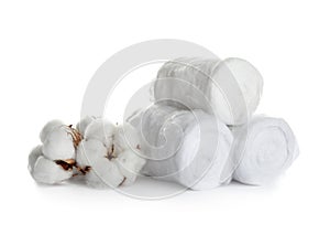 Fluffy cotton rolls and flowers on white