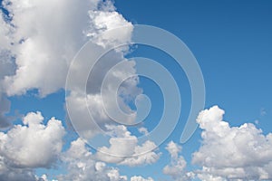 Fluffy cumulus clouds under a blue sky