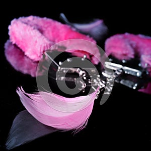 fluffy handcuffs and feathers used as adult toys