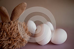 fluffy rabbit with white eggs, close up, easter card