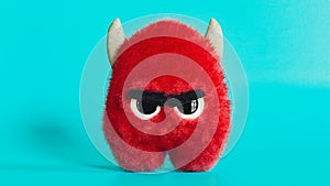 Fluffy red angry monster, devil with horns toy, funny looking furry mascot, 3d render