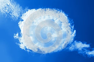 Fluffy round cloud in clear blue sky. Peaceful cloudy sky natural background, frame. Divine shining heavenly background, heaven
