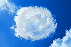 Fluffy round cloud in clear blue sky. Peaceful cloudy sky natural background, frame. Sunny day, light. Divine shining background