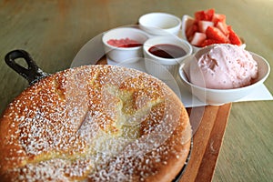 Fluffy Souffle Pancake Served with Strawberry Ice Creme and Chopped Fresh Strawberries for Topping