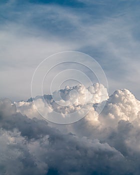 Fluffy stormy clouds in the sunset sky