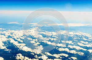 Fluffy white clouds and blue sky from airplane