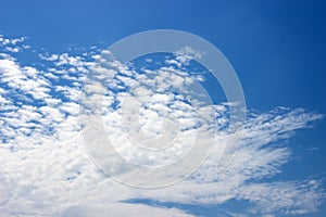 Fluffy white clouds on a blue sky. Clear sunny day. Background.