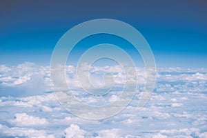 Fluffy white clouds and blue sky with copy space, airplane view