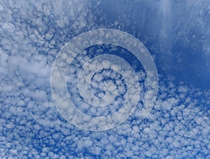 Fluffy white clouds in a blue winter sky.