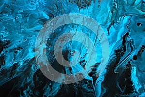 Fluid Art. Blue abstract wave swirls on black background. Marble effect background or texture