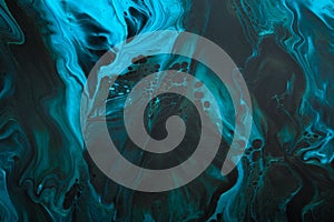 Fluid Art. Blue abstract wave swirls on black background. Marble effect background or texture