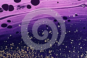 Fluid Art. Metallic gold particles and black purple waves. Marble effect background or texture