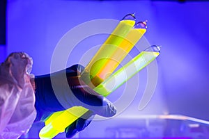 Fluorescein glowing in flask under ultraviolet ligh