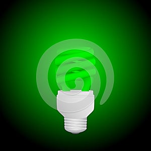 Fluorescent green economical light bulb glowing on a dark background. Save energy lamp.
