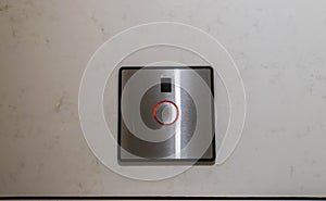 Flush button panel in modern toilet in luxury hotel