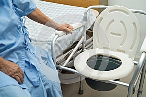 Flush toilet and shower chair in bathroom for old elder people