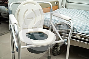 Flush toilet and shower chair in bathroom for old elder people